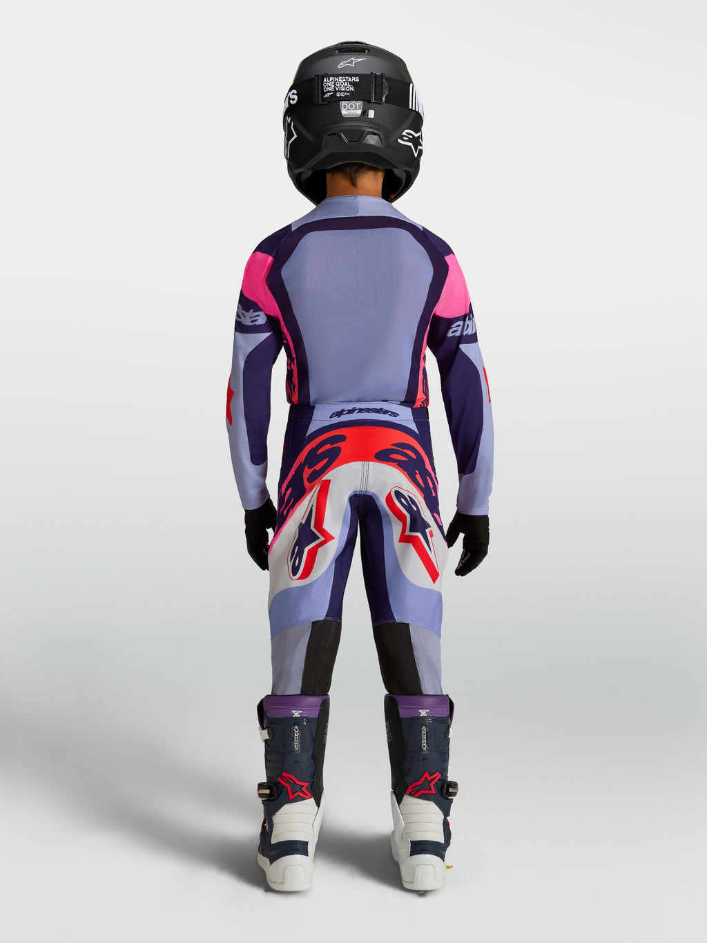 Alpinestars spodnie Supertech Dyna młodzieżowe, fioletowe i jasnofioletowe spodnie motocrossowe, widok z tyłu na zawodniku.