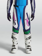 Alpinestars Supertech Maven, młodzieżowe spodnie motocrossowe, biało-niebieskie z zielonymi akcentami fluo, krój MX.