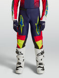 Alpinestars Fluid Drag, młodzieżowe spodnie motocrossowe, granatowe i czerwone z neonowożółtą grafiką.