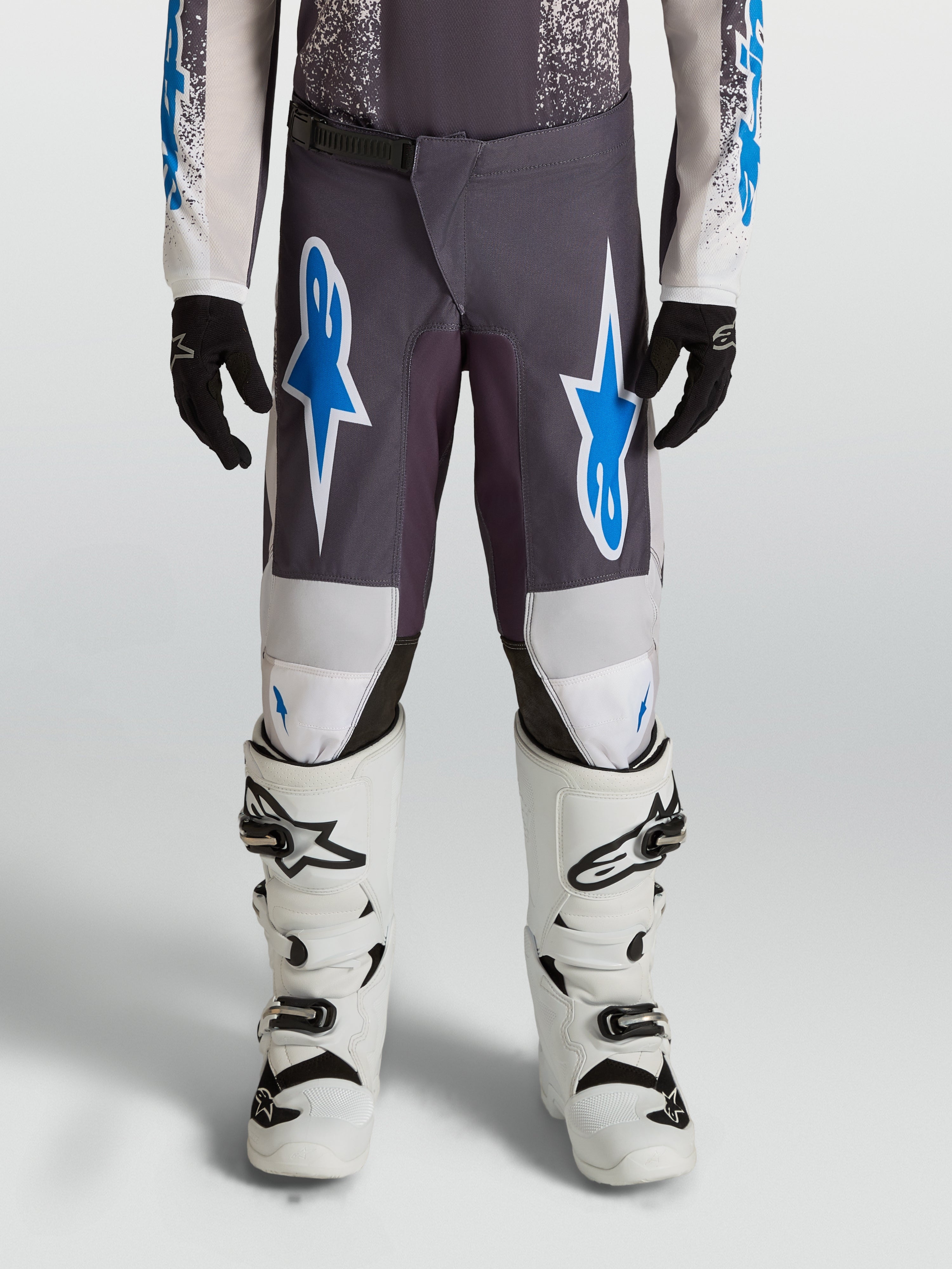 Alpinestars Spodnie Fluid Drag Młodzieżowe, spodnie motocrossowe, szare i niebieskie, wytrzymały poliester 600D, wzmocnienia na kolanach, odzież MX