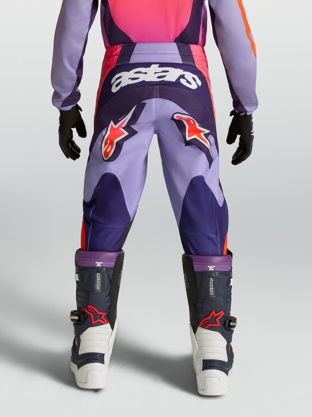 Alpinestars Fluid Hunt, fioletowe i różowe młodzieżowe spodnie motocrossowe z logo astars, trwała odzież terenowa.