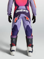 Alpinestars Fluid Hunt, fioletowe i różowe młodzieżowe spodnie motocrossowe z logo astars, trwała odzież terenowa.