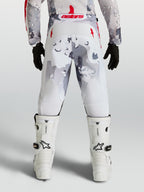 Alpinestars Youth Fluid Lone Pants, Gray Camo and White motocross pants with Red accents, rear view on rider.