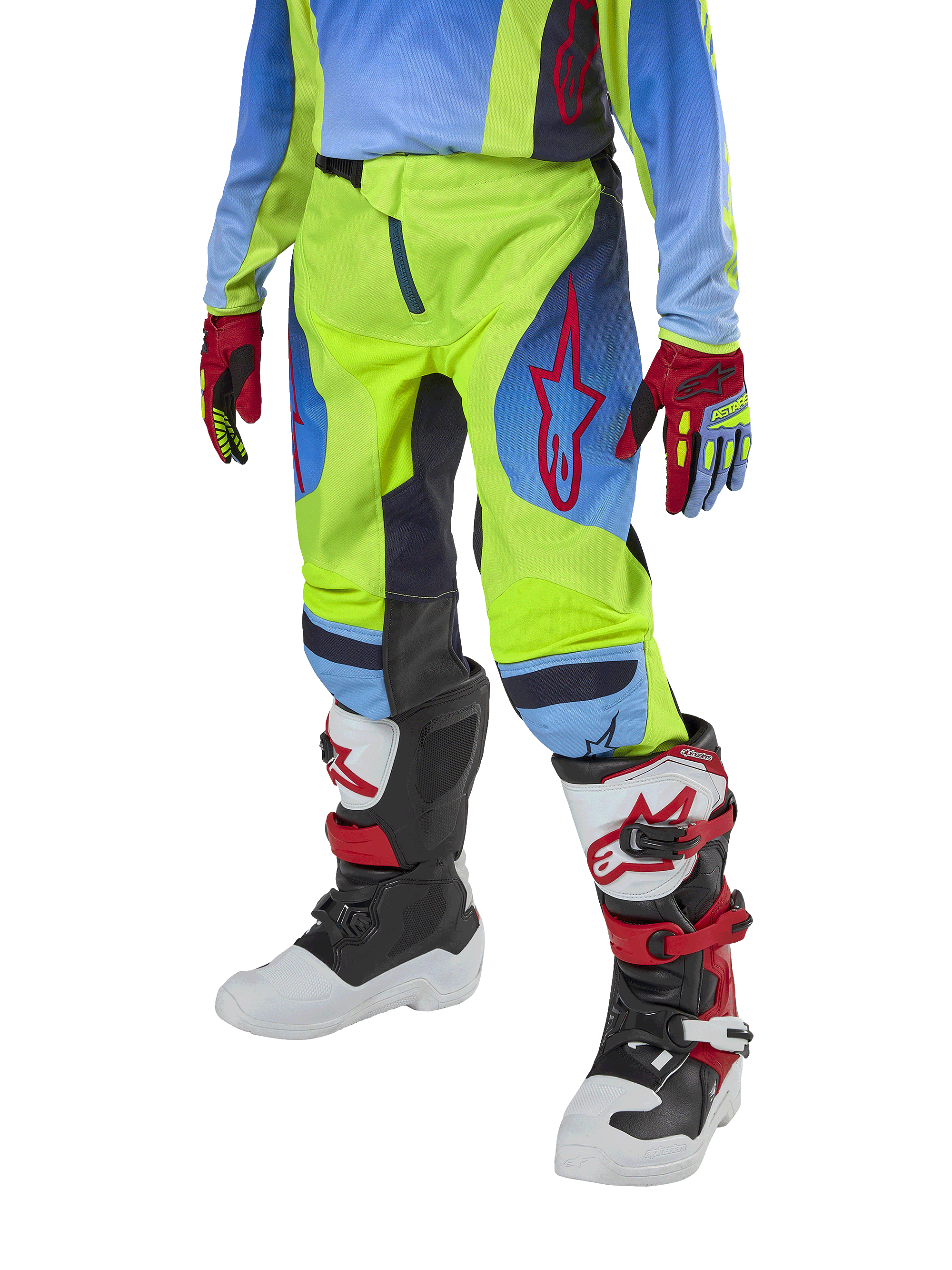 Alpinestars Youth 2024 Racer Hoen Pants, spodnie motocrossowe, żółte neonowe i granatowe z czerwonymi akcentami, zestawione z pasującymi rękawicami oraz białymi, czarnymi i czerwonymi butami, o sportowym kroju z profilowanymi nogawkami do wyścigów off-road