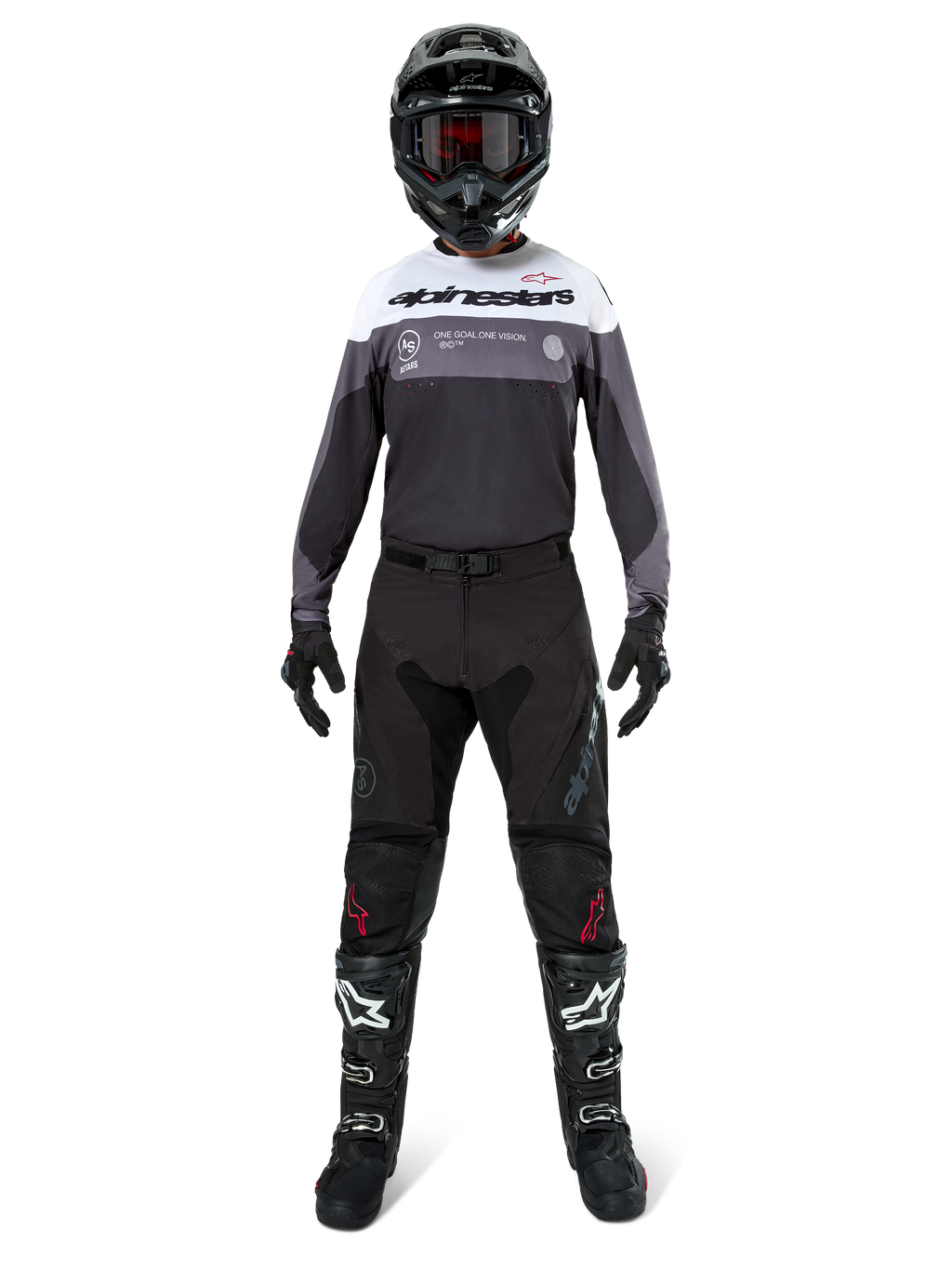 Motocross rider wearing complete racing gear, Pro-Dura Jersey in Black Magnet White with white upper chest and grey accents, paired with black pants, black helmet with dark goggles, white and black boots, and black gloves, coordinated outfit for enduro and off-road racing
