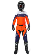 Motocross rider wearing complete Alpinestars Pro-Dura gear, Navy Hot Orange and White jersey, matching orange and navy pants, black motocross boots with white logos, black helmet and gloves, coordinated outfit for off-road racing