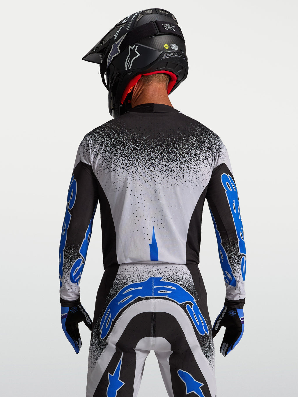 Alpinestars Supertech Hiten AFD, męska koszulka motocrossowa, czarna i niebieska, widok z tyłu, sportowy krój.