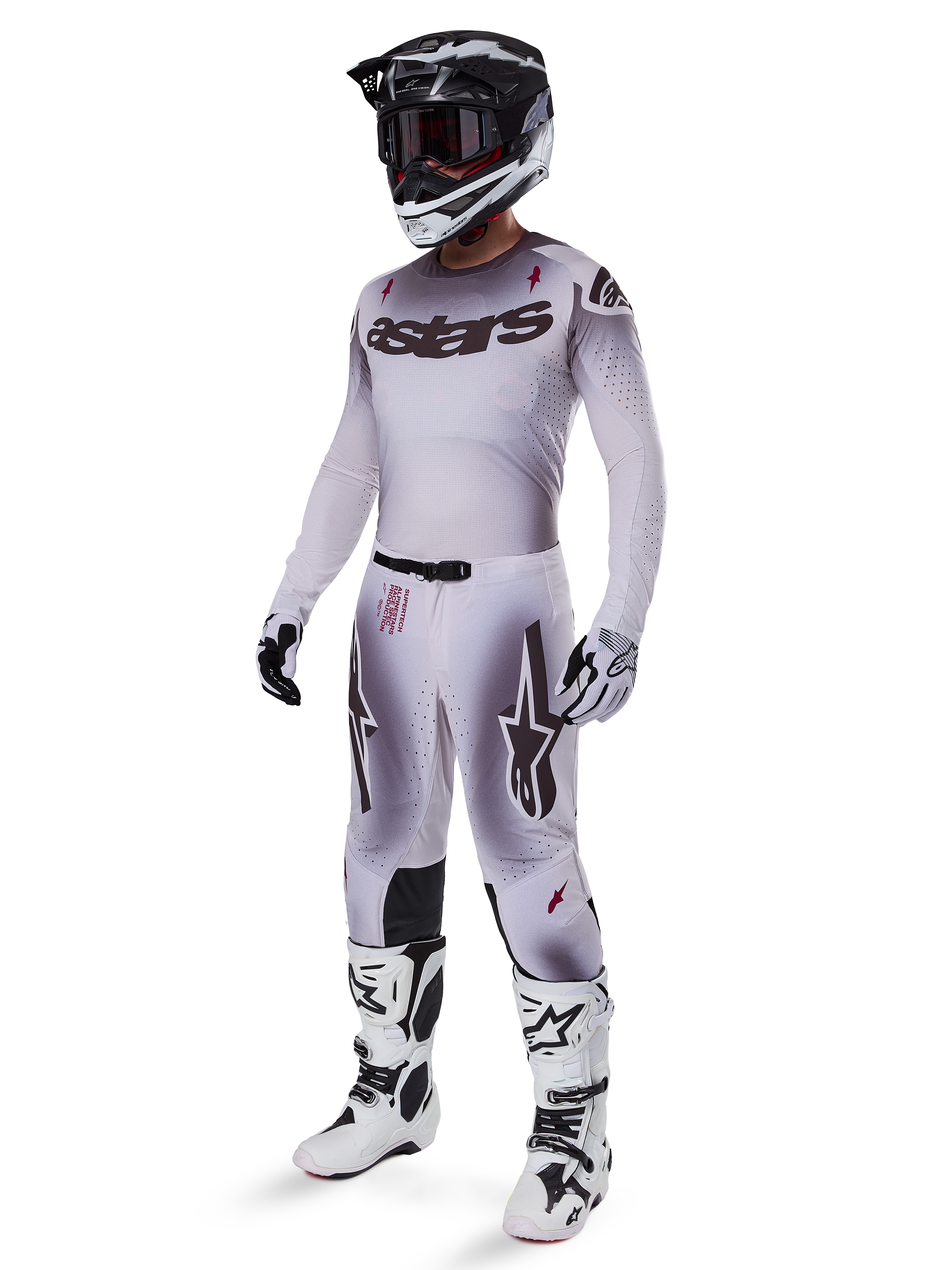 Alpinestars 2025 Supertech Maker Gear Set, complete motocross outfit, white and grey gradient with black branding and red accents, includes helmet with goggles, jersey, pants, white boots, and gloves, sleek performance-driven design for off-road racing