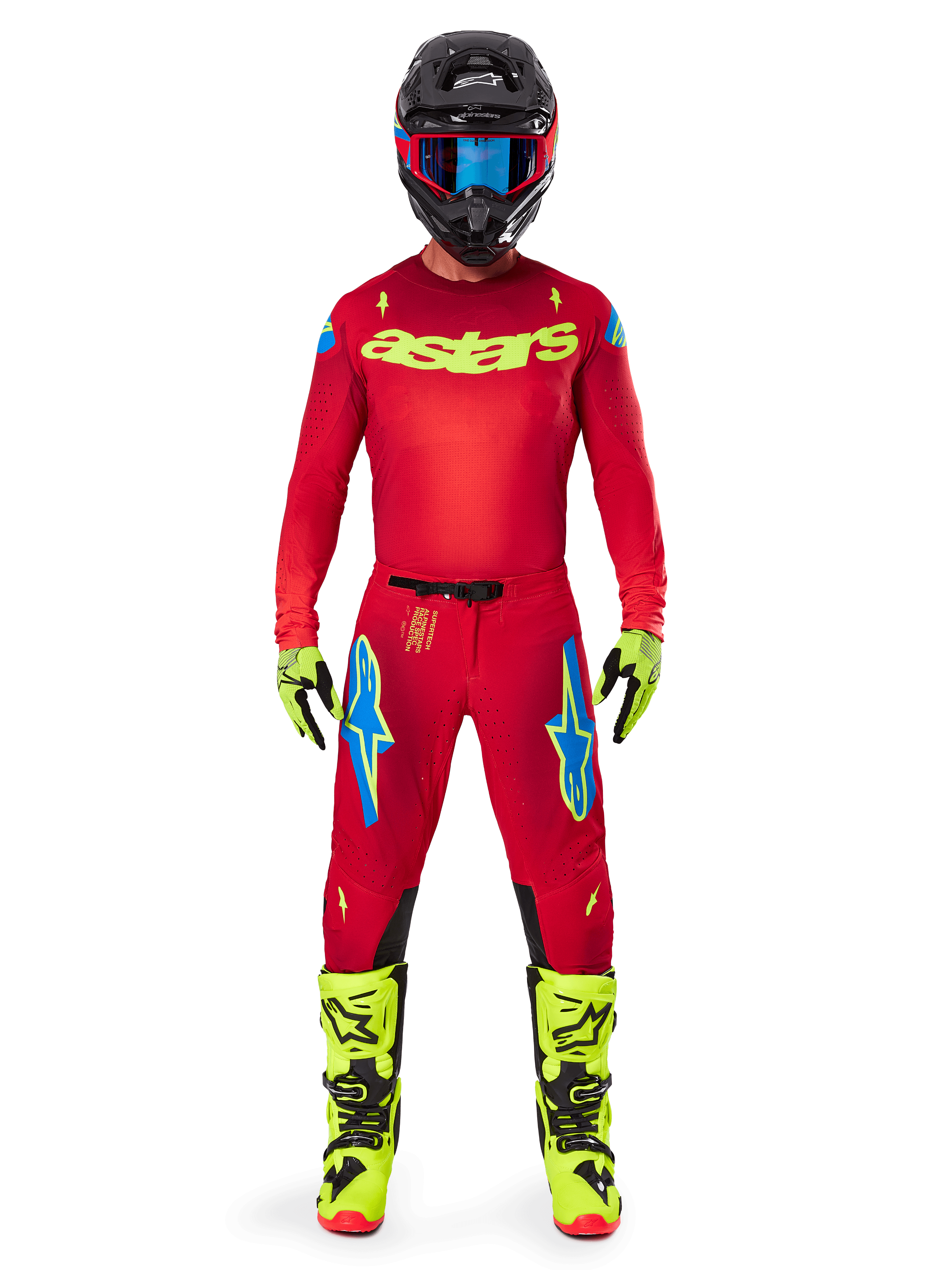 Motocross rider wearing the Alpinestars 2025 Supertech Maker Jersey and matching pants in Bright Red and Yellow Fluo, featuring yellow 'astars' branding on the chest, black helmet with blue goggles, yellow-fluo gloves and boots, complete professional racing outfit for off-road performance.