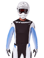 Alpinestars 2025 Techstar Melt Jersey, Motocross Racing Gear, Black White and Blue, Long Sleeve Jersey with matching pants and gloves, Rider wearing complete MX outfit with white helmet and goggles