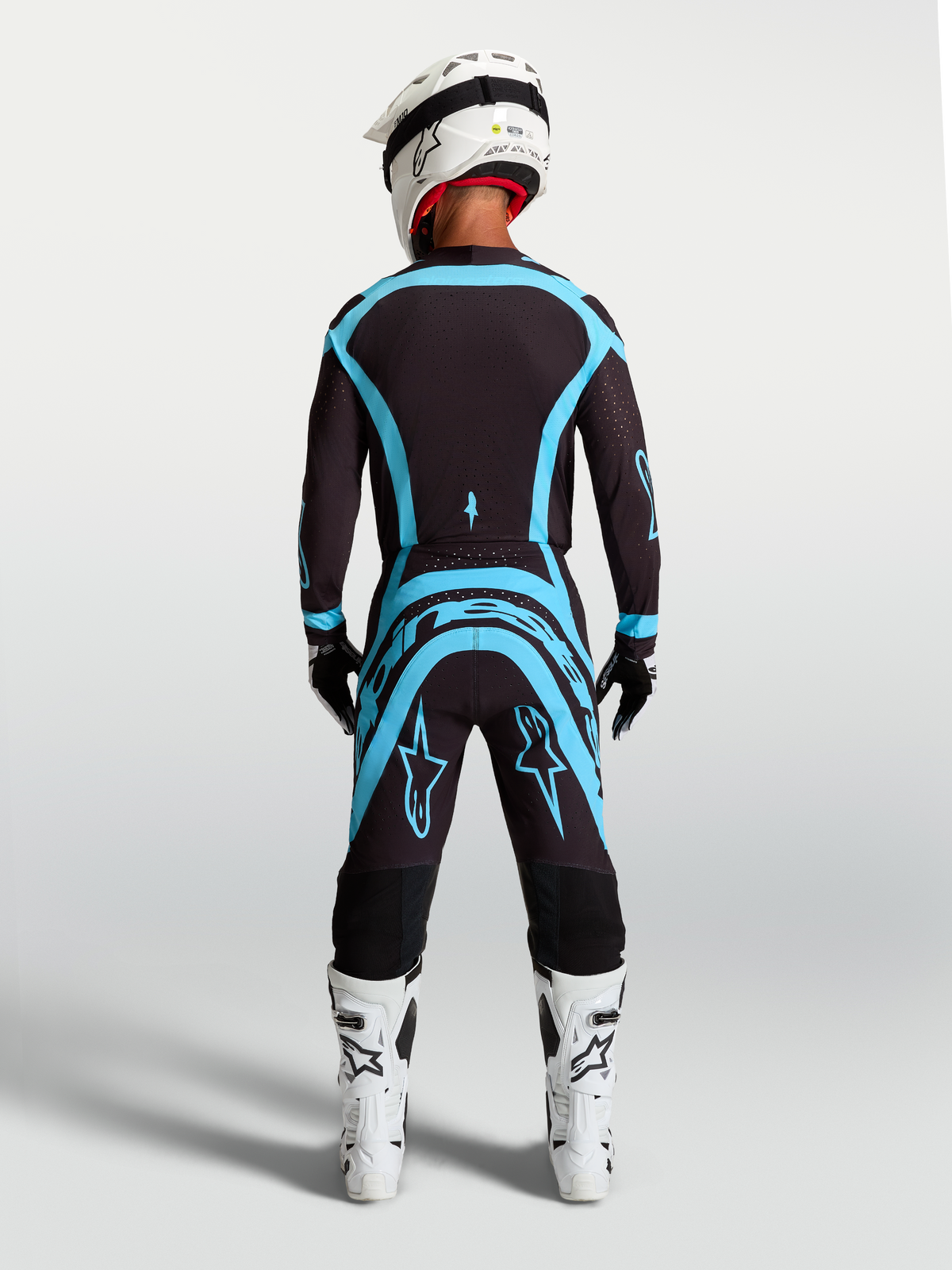 Alpinestars Supertech Vesta gear set i koszulka, męski zestaw motocrossowy, czarno-turkusowy, widok z tyłu, sportowy krój