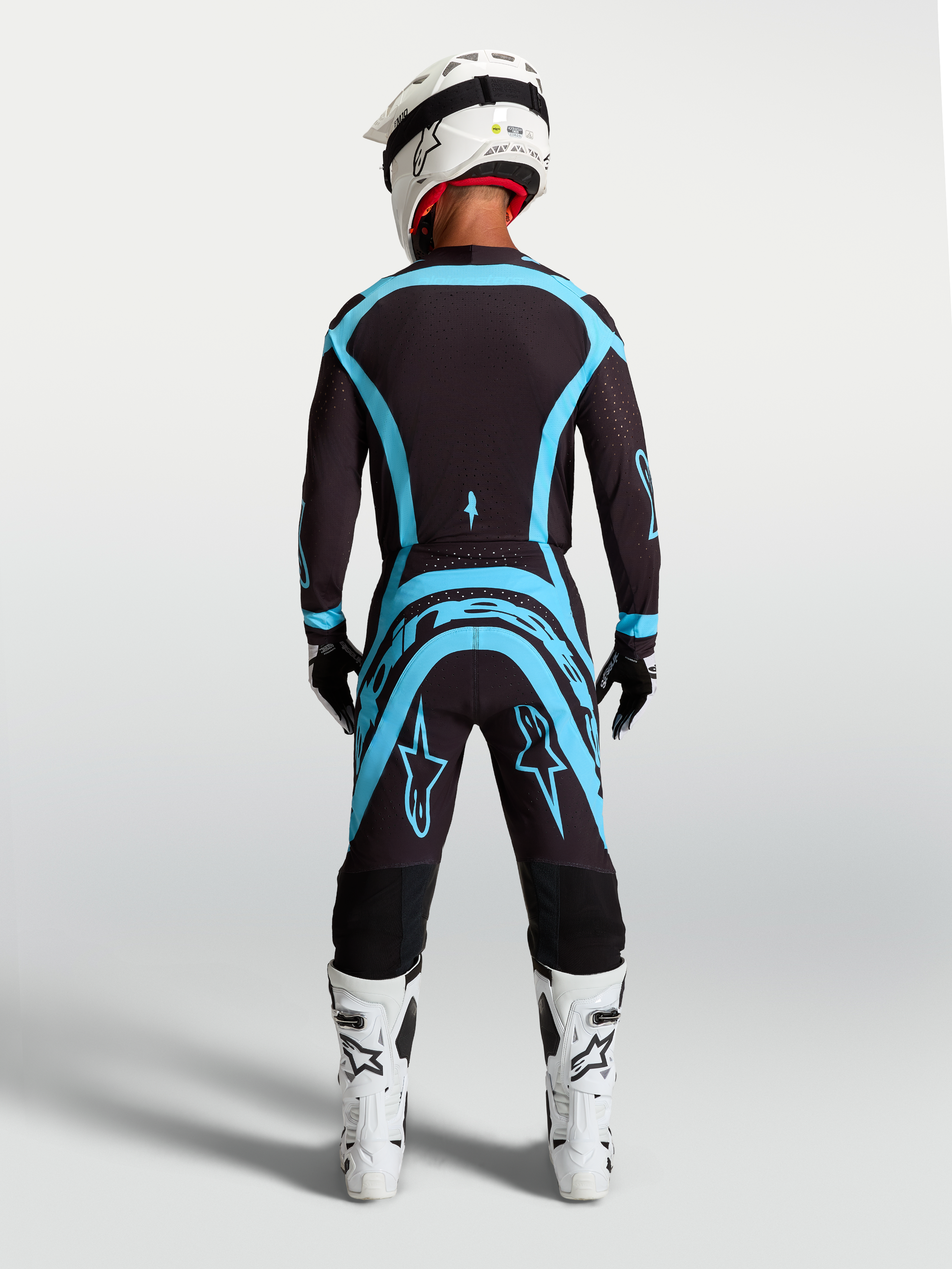 Alpinestars Supertech Vesta Jersey and Gear Set, professional black and turquoise motocross racing outfit with athletic fit.
