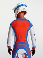 Alpinestars Koszulka Supertech Vesta, męska koszulka MX, czerwona, biała i niebieska, wentylowany panel z siatki na plecach.