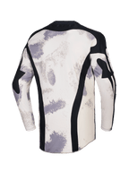 Alpinestars 2026 Racer Lahnd Jersey, koszulka motocrossowa, kolor Sand Camo z białawymi i szarymi wzorami pociągnięć pędzla, widok z tyłu z pionowymi czarnymi panelami z siatki, czarny kołnierzyk i przedłużony tył dla lepszej osłony.