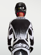 Alpinestars koszulka Techstar Swan, męska koszulka motocrossowa, czarna i biała, sportowy krój wyścigowy, widok z tyłu.