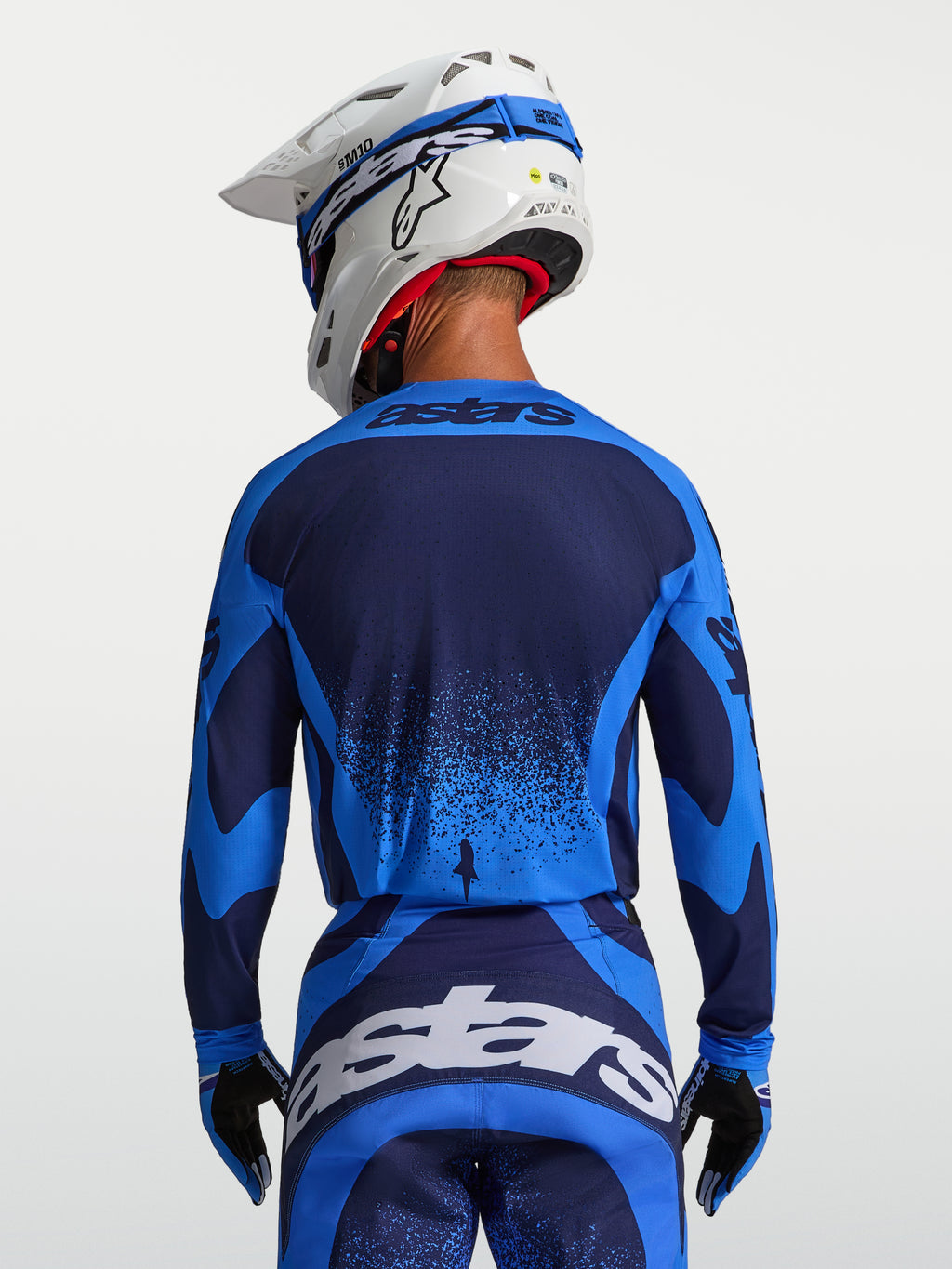 Alpinestars Techstar Swan, męska koszulka motocrossowa, niebieska i granatowa, widok z tyłu na sportowy krój wyścigowy.