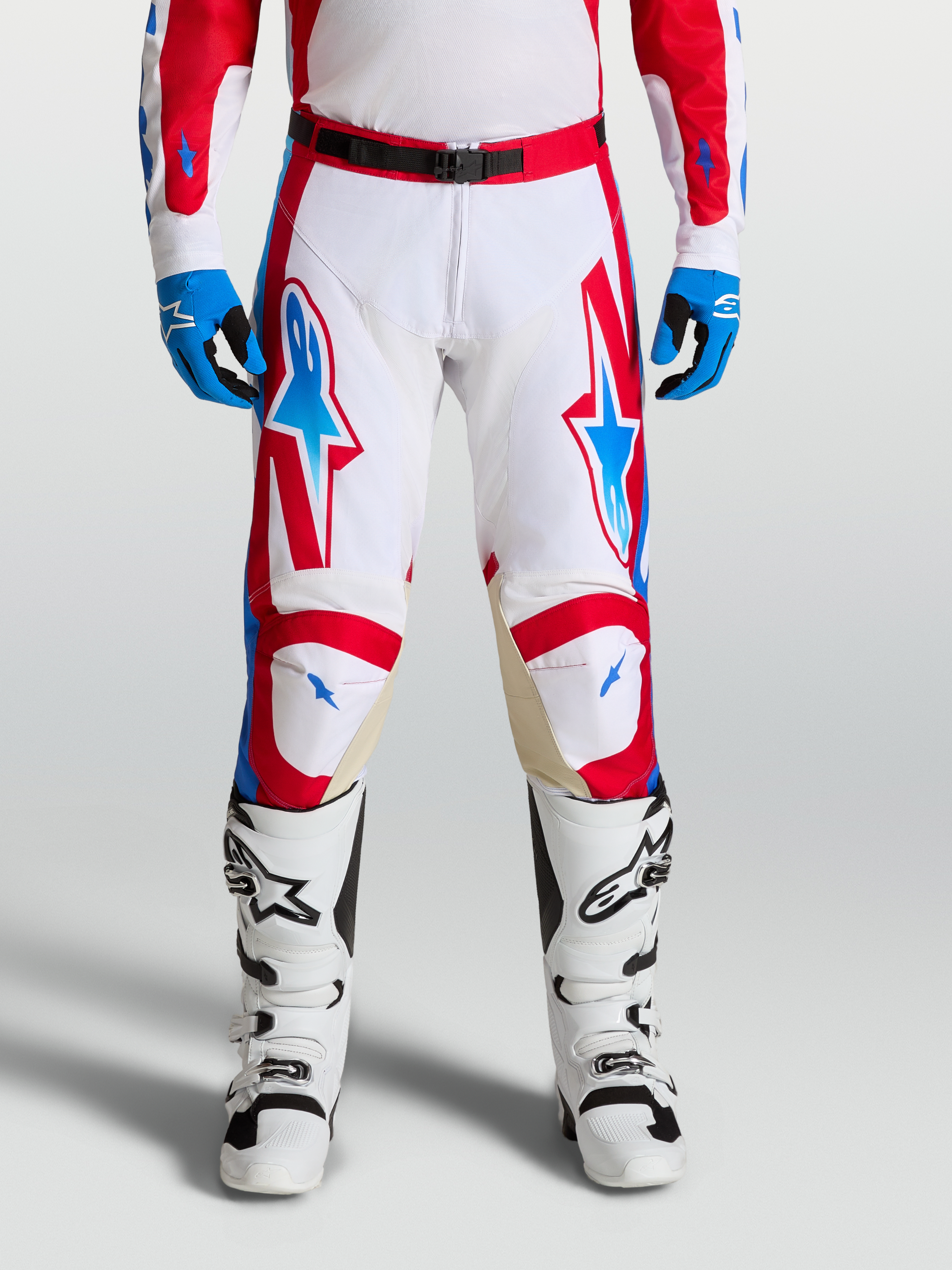 Alpinestars Spodnie Racer Hunt, spodnie motocrossowe męskie, białe i czerwone z niebieskimi detalami, ergonomiczna konstrukcja z panelami skórzanymi na kolanach, wersja on-model