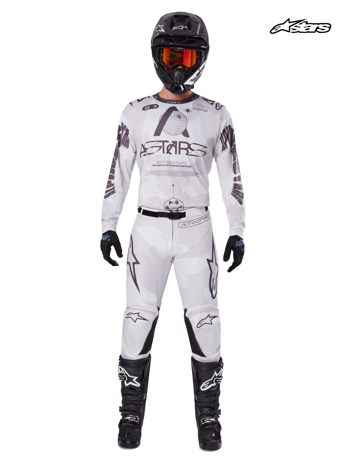 Alpinestars 2025 Racer Hollow Gear Set, men's motocross jersey and pants in light camo brown and white, front studio view on a model wearing matching helmet, gloves, and boots, lightweight performance off-road riding apparel.