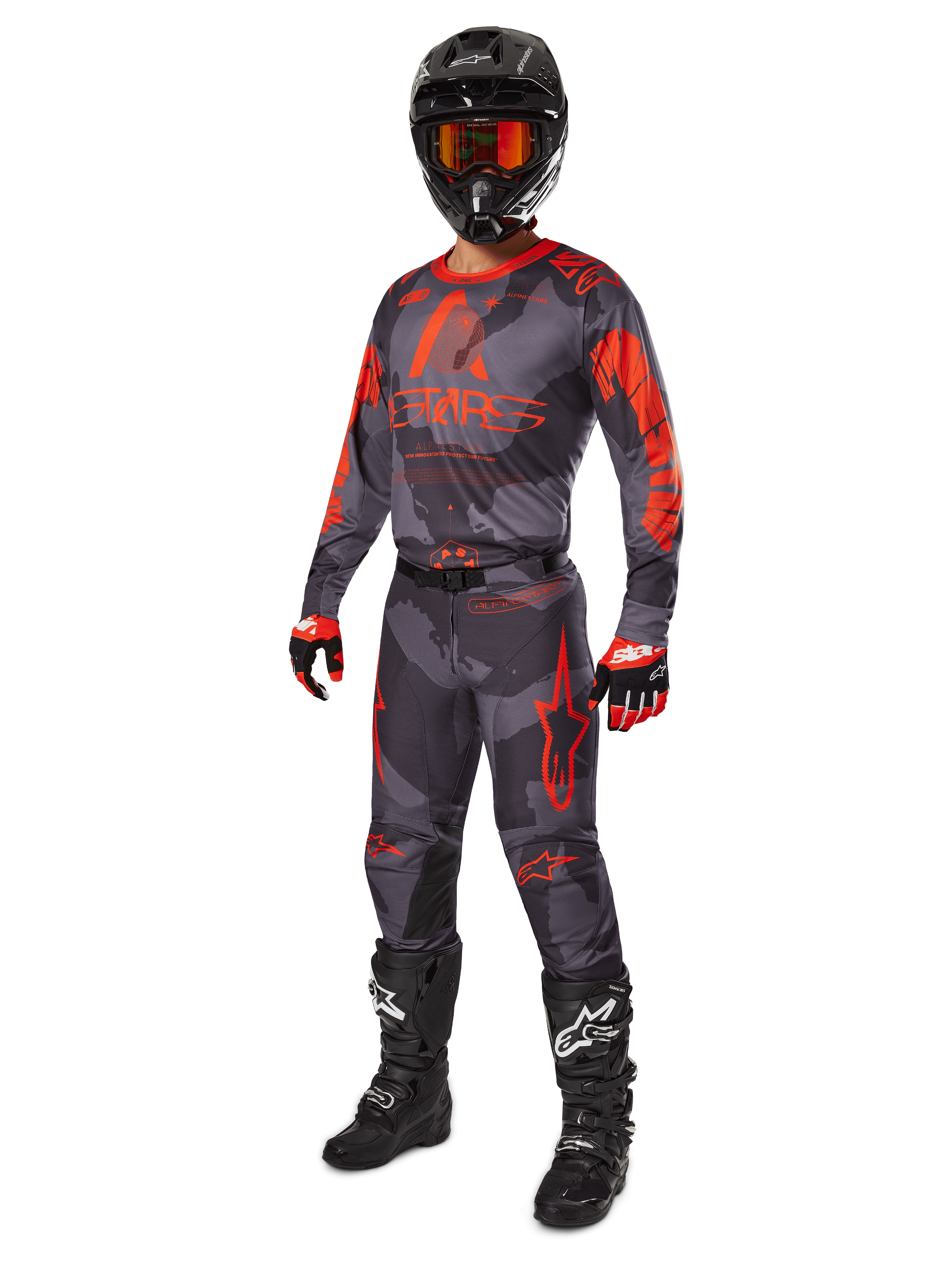 Alpinestars 2025 Racer Hollow Gear Set, kompletny strój motocrossowy, szary kamuflaż i pomarańczowy fluo, zawiera czarny kask z goglami o czerwonym odcieniu, koszulkę i spodnie moro z wyrazistymi pomarańczowymi grafikami, czerwono-czarne rękawice oraz czarne buty z białym logo, ochronne wyposażenie terenowe