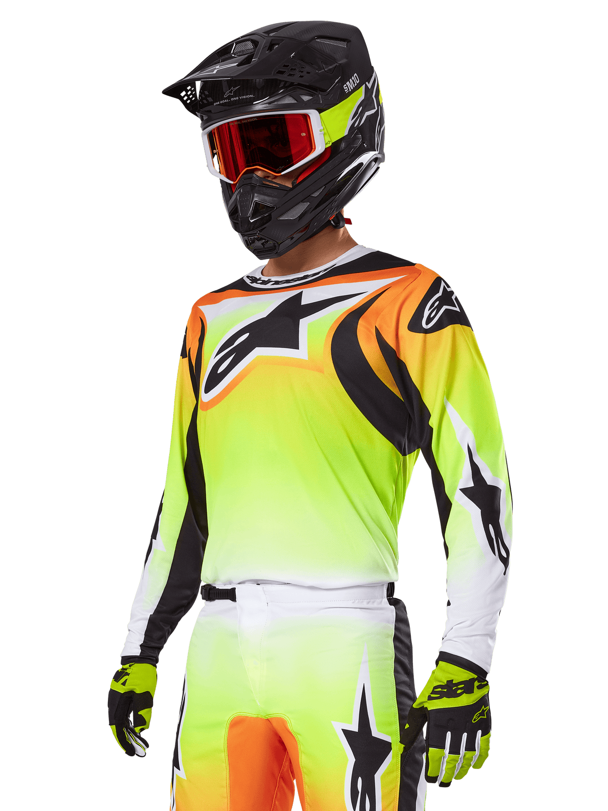Motocross rider wearing Alpinestars 2025 Fluid Wurx Gear Set, Yellow and Orange gradient jersey with black accents and large star logos, matching motocross pants, black full-face helmet with red-tinted goggles, and yellow gloves, coordinated high-performance outfit for off-road racing