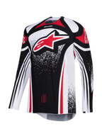 Alpinestars Techstar Nomur Jersey 2026, koszulka motocrossowa, czarno-biało-czerwona, z dużym czerwonym logo Astars na klatce piersiowej, kropkowane wzory graficzne, długie rękawy, sportowy krój wyścigowy do wyczynowej jazdy terenowej.
