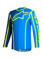 Alpinestars 2026 Fluid Apex Jersey, koszulka motocrossowa, niebieska i żółta fluo, duże neonowożółte logo gwiazdy na klatce piersiowej, długie rękawy z granatowymi i jasnoniebieskimi sekcjami, pionowe logo na ramieniu, sportowa odzież off-road