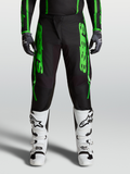 Spodnie Alpinestars Fluid Apex V2 2027, męska odzież motocrossowa, zielone i czarne, wzmocnione kolana i białe buty.