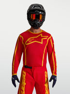 Alpinestars Fluid Apex V2, męska koszulka motocrossowa, czerwona i złota, lekki materiał odprowadzający wilgoć.
