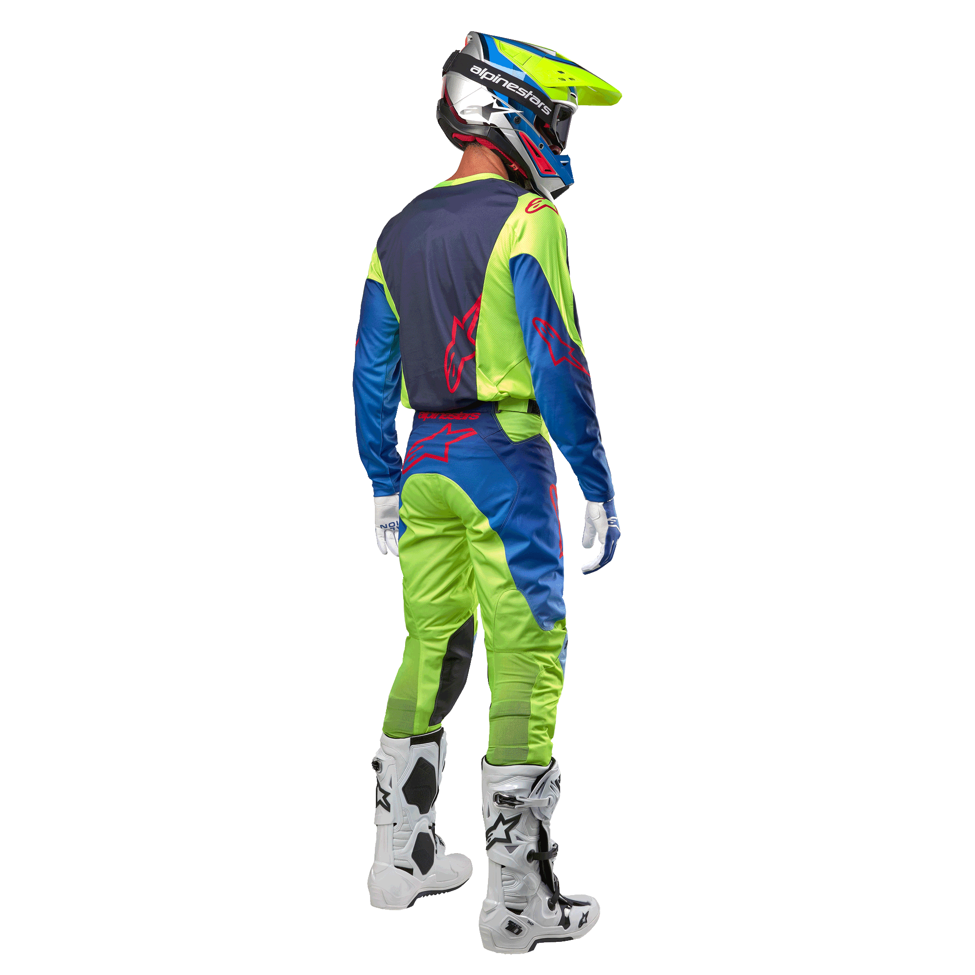 Zawodnik motocrossowy widoczny od tyłu w koszulce Alpinestars 2024 Racer Hoen w kolorze żółtym neonowym i granatowym, dopasowane spodnie motocrossowe i białe buty, pokazujący tylny design z czerwonymi logo, profesjonalny strój do wyścigów terenowych