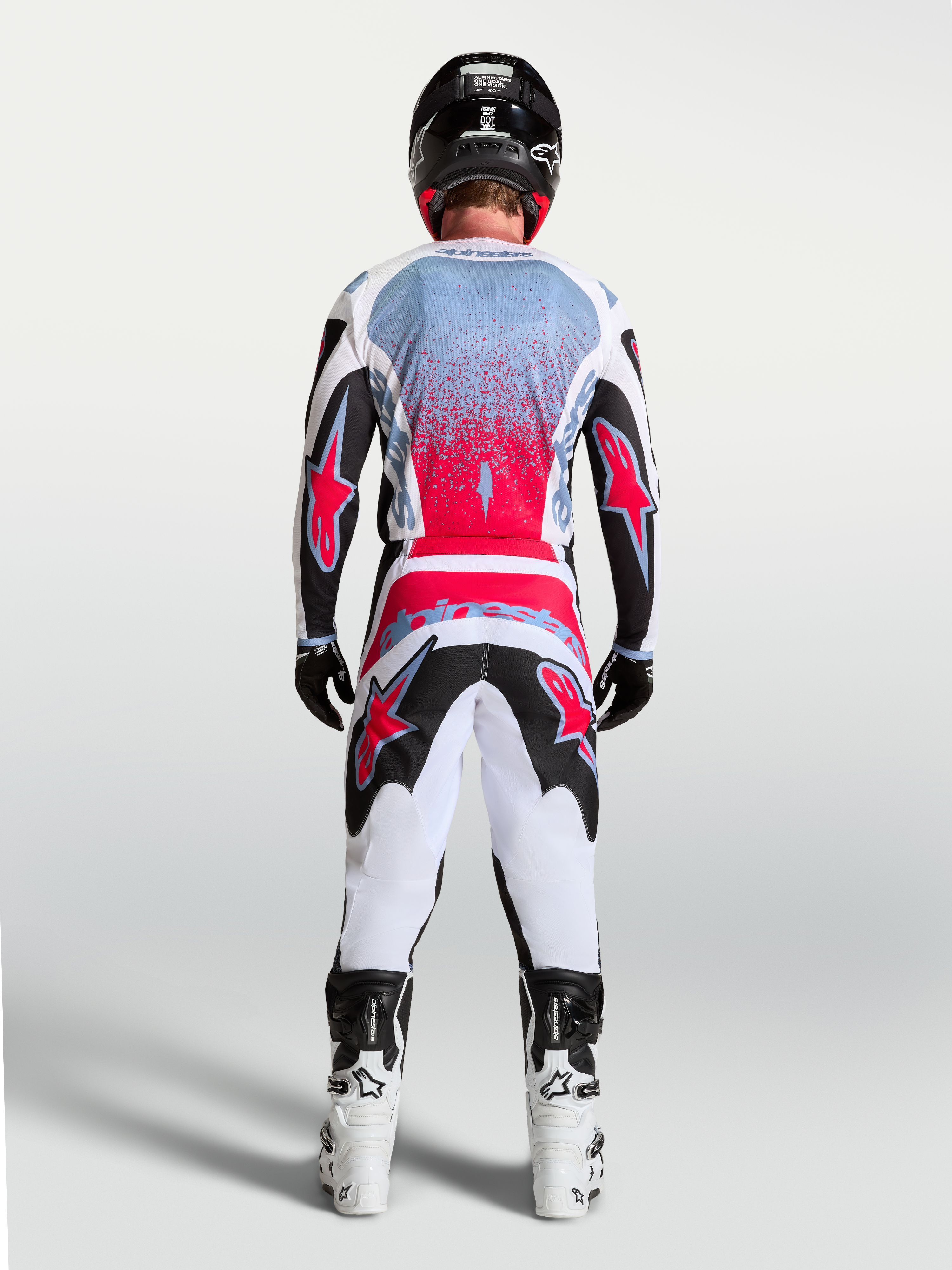Alpinestars Fluid Drag Jersey, Men's Motocross Racing Jersey in Black and Red Fluo, shown from a rear view on a rider.