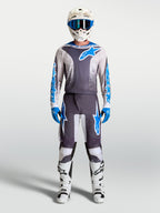 Alpinestars 2027 Fluid Drag Gear Set, szary i niebieski zestaw odzieży motocrossowej, wyścigowa koszulka i spodnie.