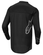 Alpinestars Fluid Graphite Jersey, Motocross Jersey, Black and Dark Gray, Back View, featuring large gray Alpinestars logo on the side and sleeve graphics, lightweight moisture-wicking textile for off-road racing