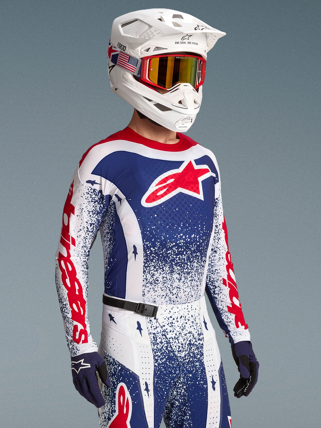 Koszulka Alpinestars Techstar Unity Limited Edition, czerwono-niebieski wzór splatter, męski model do wyścigów motocross.