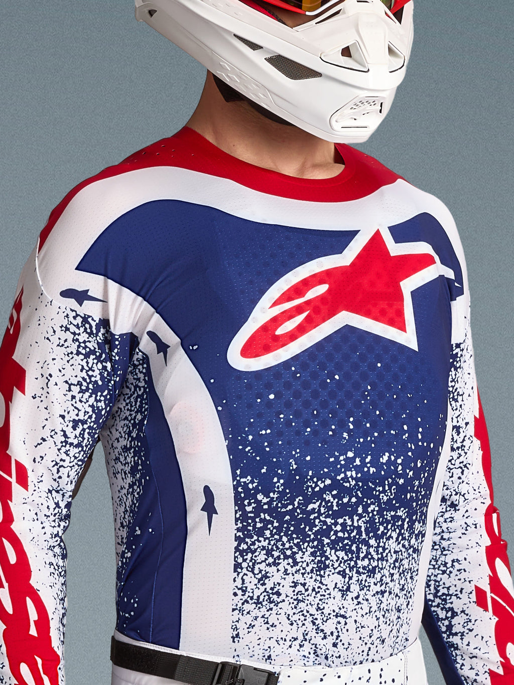 Alpinestars Techstar Unity Jersey, męska koszulka motocrossowa, niebiesko-biała z czerwonym logo gwiazdy, edycja limitowana.