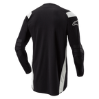 Koszulka Alpinestars Techdura, koszulka enduro motocross, czarna z białymi akcentami, widok z tyłu z przedłużonym tyłem, wzmocnionymi łokciami i białym logo Alpinestars na rękawie, wytrzymała odzież do jazdy terenowej