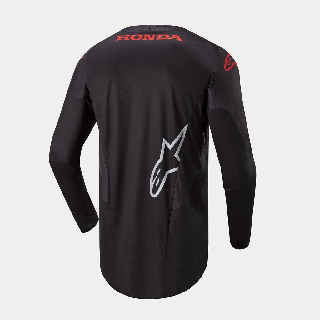 Alpinestars Koszulka Honda Racer Iconic, czarna męska koszulka motocrossowa z długim rękawem i przedłużonym tyłem, widok z tyłu przedstawiający czerwone logo Honda i białą grafikę Alpinestars