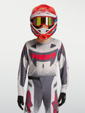 Młodzieżowy zestaw Alpinestars Supertech Swan, szaro-czerwona koszulka i spodnie motocrossowe z oddychającej siatki stretch.