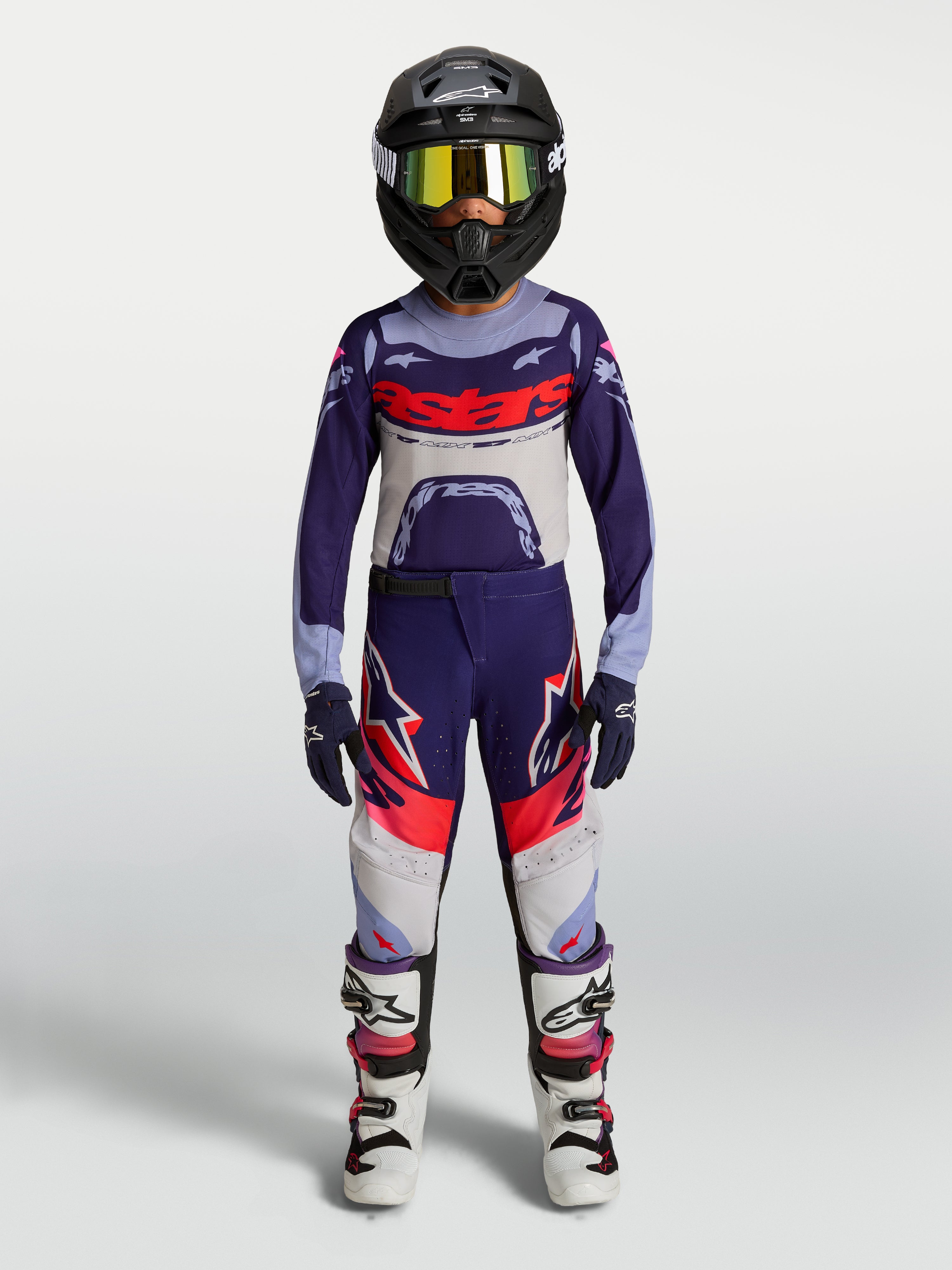 Alpinestars 2027 Youth Supertech Dyna, zestaw i koszulka MX, fioletowo-biały strój młodzieżowy z kaskiem i butami.