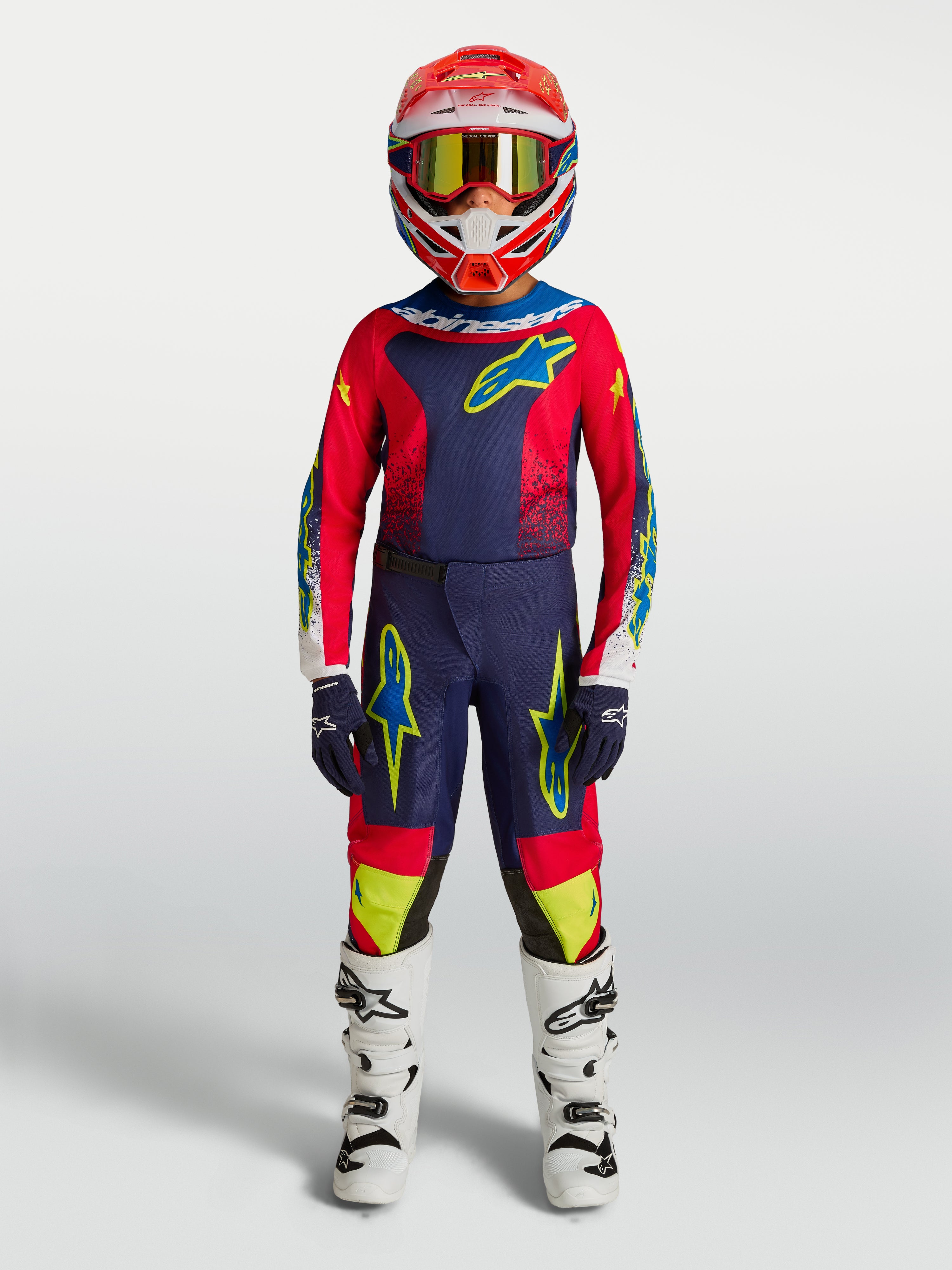 Alpinestars 2027 Youth Fluid Drag, granatowy i czerwony młodzieżowy zestaw motocrossowy, białe buty, kask, ubiór terenowy.