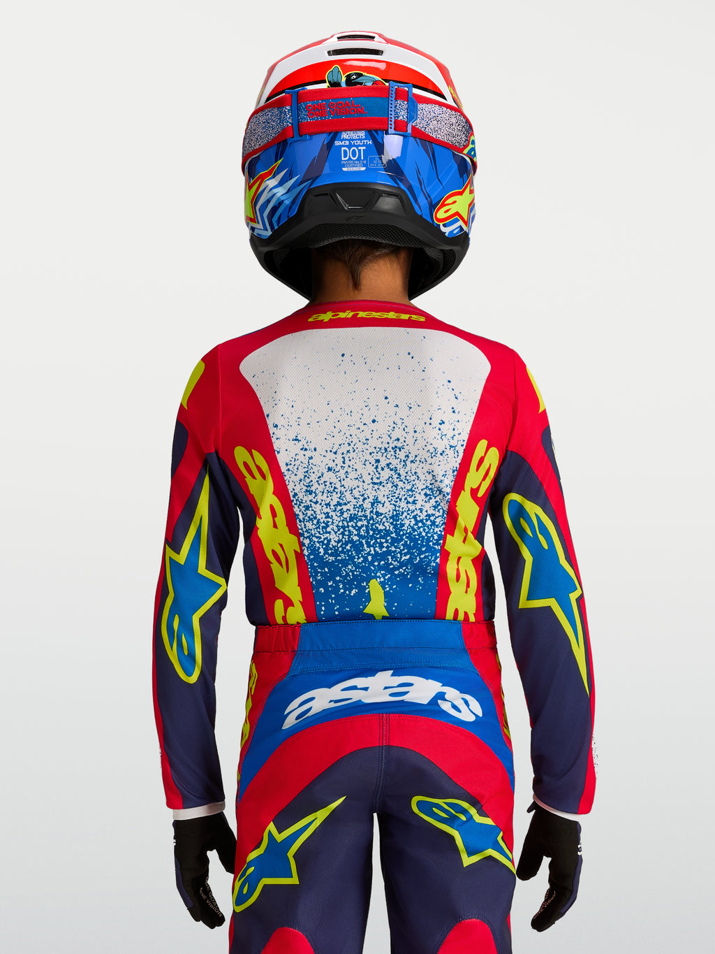 Alpinestars koszulka Fluid Drag młodzieżowe, koszulka motocrossowa, niebieska i czerwona, widok z tyłu na ergonomiczny krój wyścigowy.