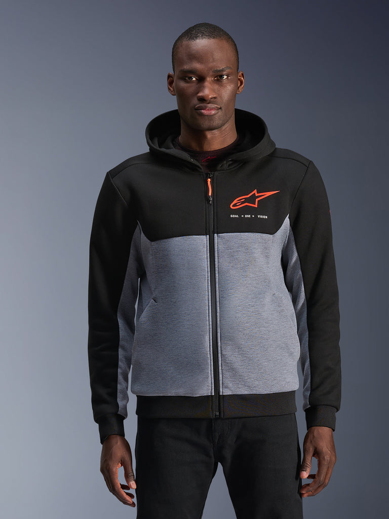 Alpinestars Chrome V2 Sport Hoodie, Urban Motorcycle Riding Hoodie, Black and Gray Heather with Red Fluo accents, featuring the Alpinestars logo and "GOAL ONE VISION" text, casual protective gear for urban riding, worn by a model against a gray background.