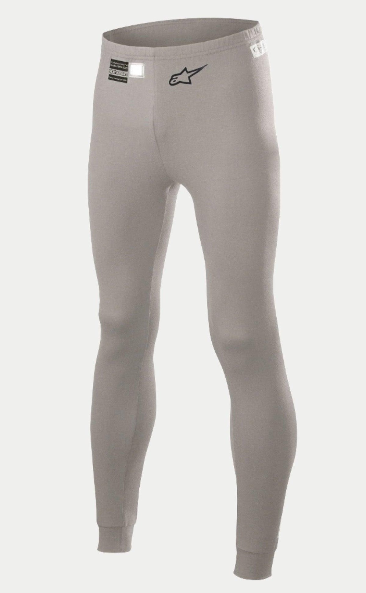 Alpinestars Race V2 Bottom FIA, samochodowa bielizna techniczna, szara, z czarnym logo gwiazdy na nogawce i etykietą homologacji FIA na pasie, lekka ognioodporna tkanina ze ściągaczami przy kostkach.