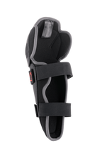 Alpinestars Bionic Action Knee Protector, ochraniacz motocrossowy na kolana, czarno-szary, widok od wewnątrz z podwójnym systemem elastycznych pasków, piankową wyściółką i ergonomiczną asymetryczną konstrukcją do jazdy off-road