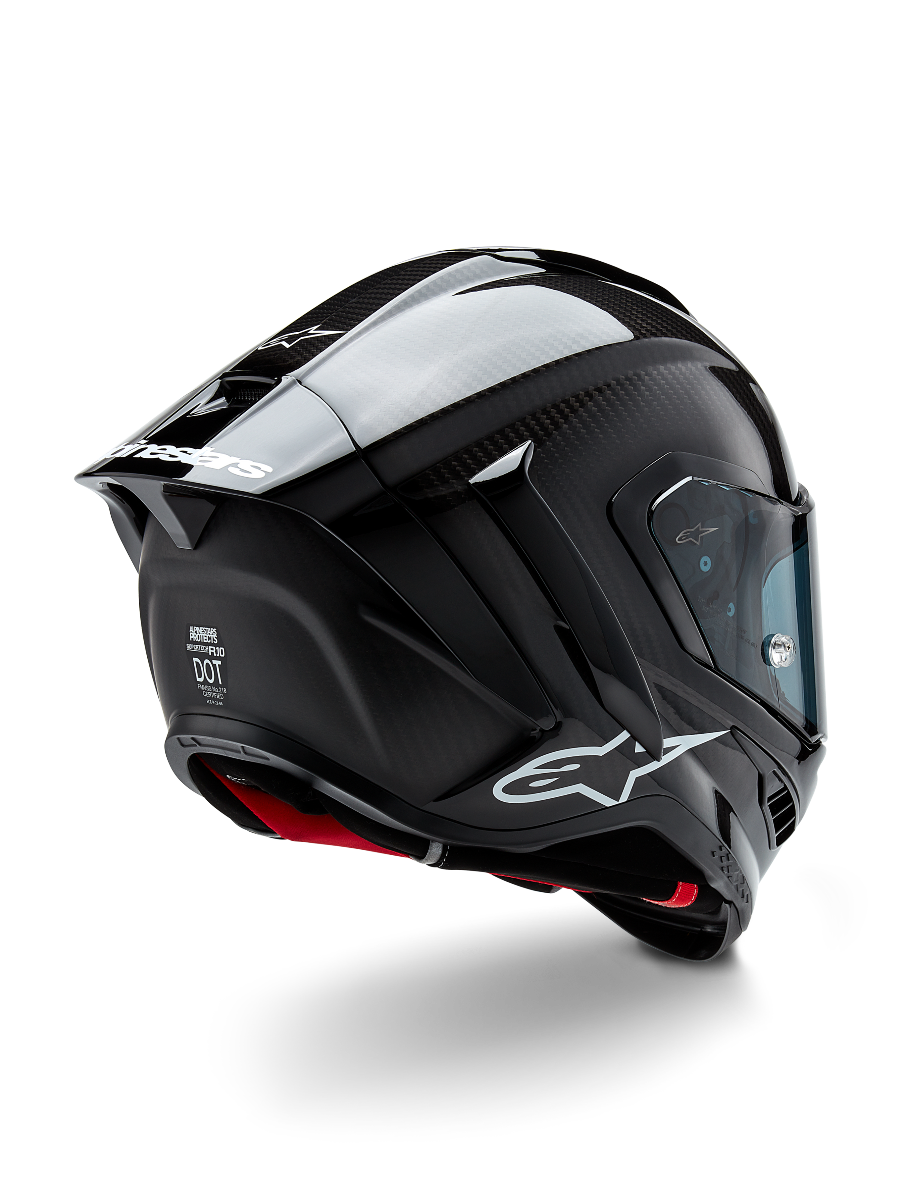 Kask Alpinestars Supertech R10 Solid, wyścigowy kask motocyklowy, czarne wykończenie z włókna węglowego (mat i połysk), widok z tyłu pod kątem trzech czwartych ukazujący karbonową skorupę, aerodynamiczny spojler oraz logo Alpinestars.