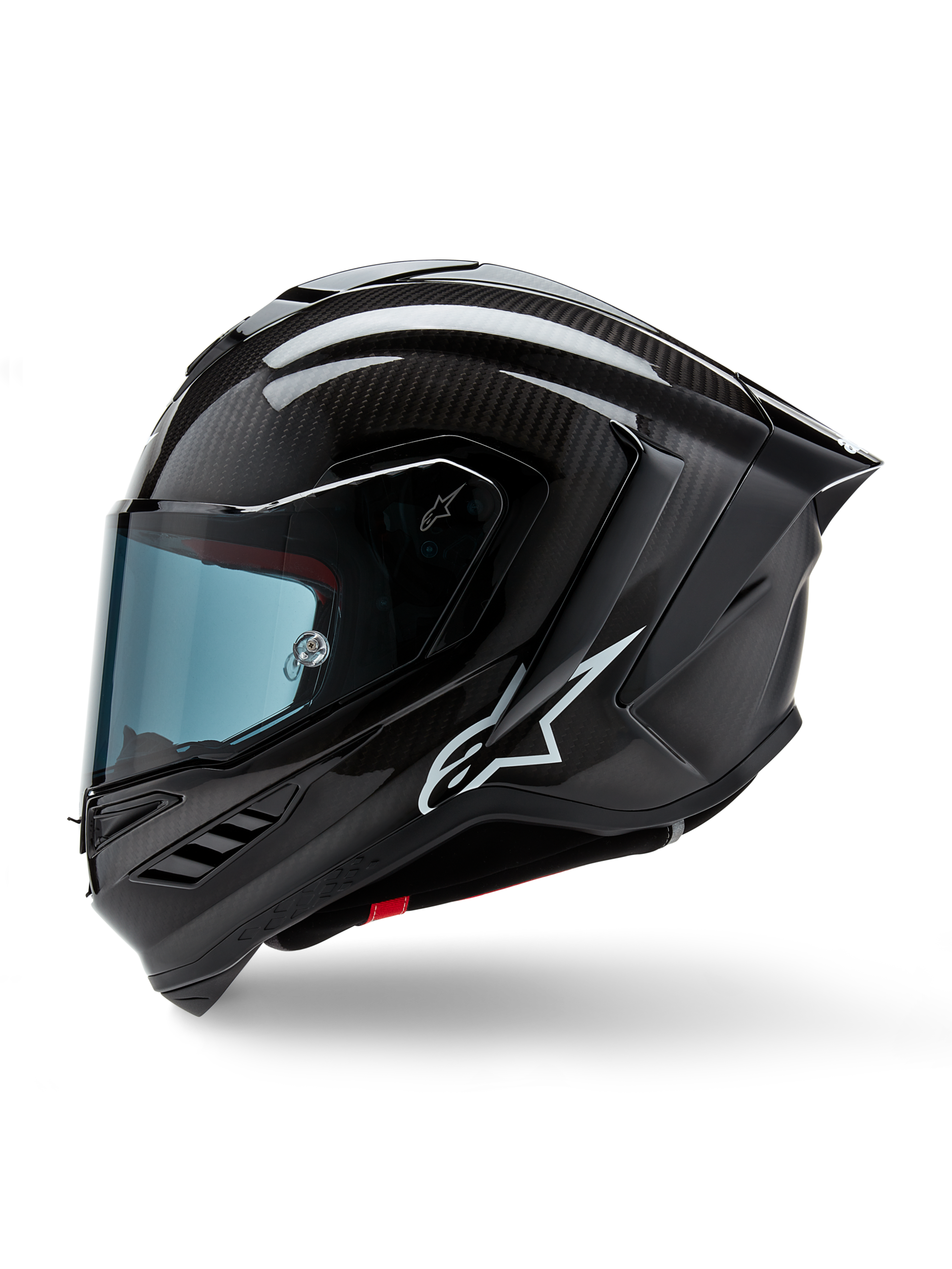 Alpinestars Supertech R10 Solid Helmet, motocyklowy kask wyścigowy, czarny karbon matowy i błyszczący, widoczny splot włókna węglowego, białe logo Alpinestars z boku, aerodynamiczna konstrukcja ze zintegrowanym tylnym spojlerem i otworami wentylacyjnymi, widok z profilu bocznego
