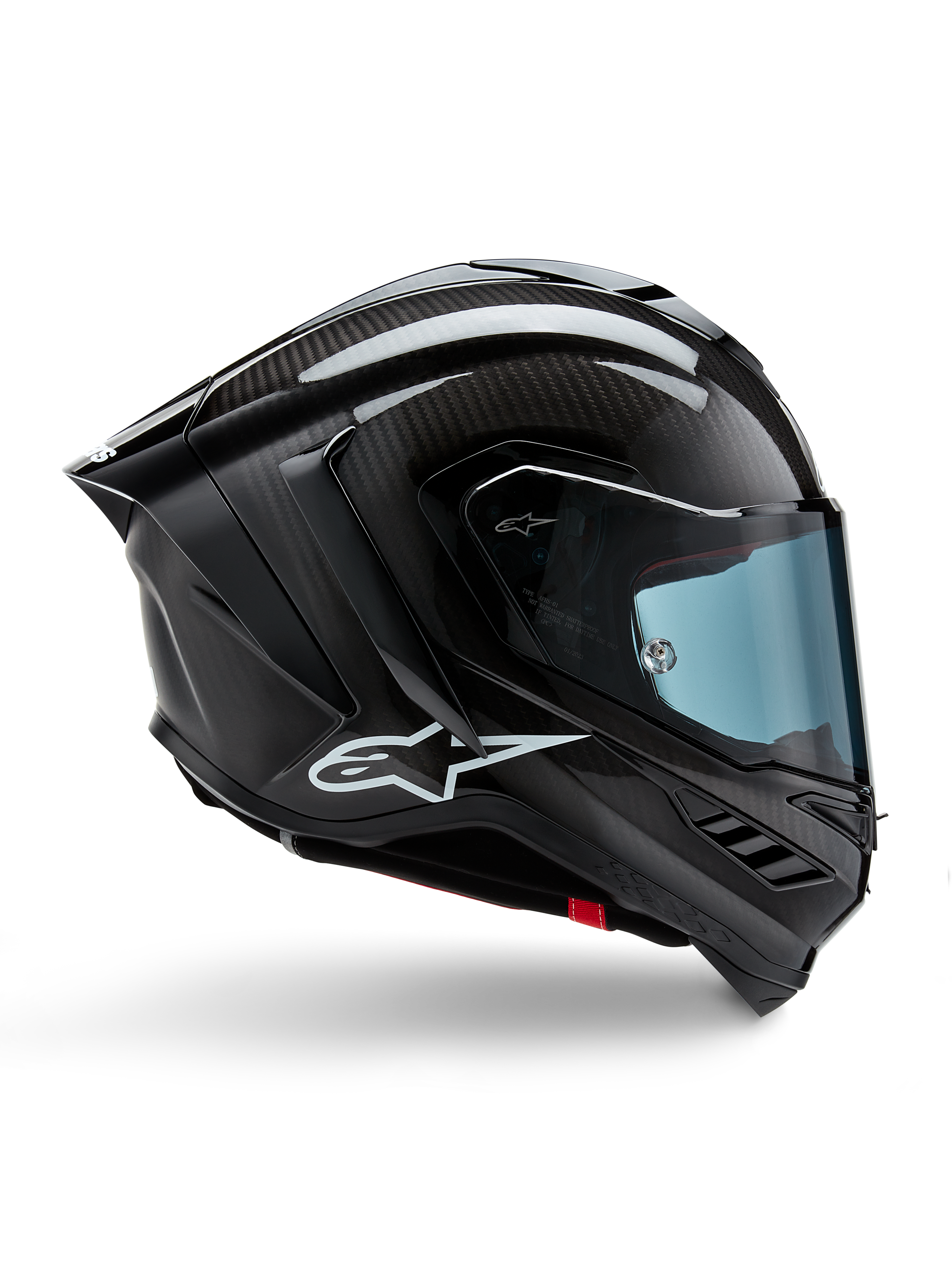 Kask Alpinestars Supertech R10 Solid, czarny karbon matowy i błyszczący, motocyklowy kask wyścigowy, konstrukcja z włókna węglowego, profil boczny, błękitna przyciemniana szyba, aerodynamiczny design ze skrzydełkami, białe logo, wysokowydajna ochrona na poziomie MotoGP