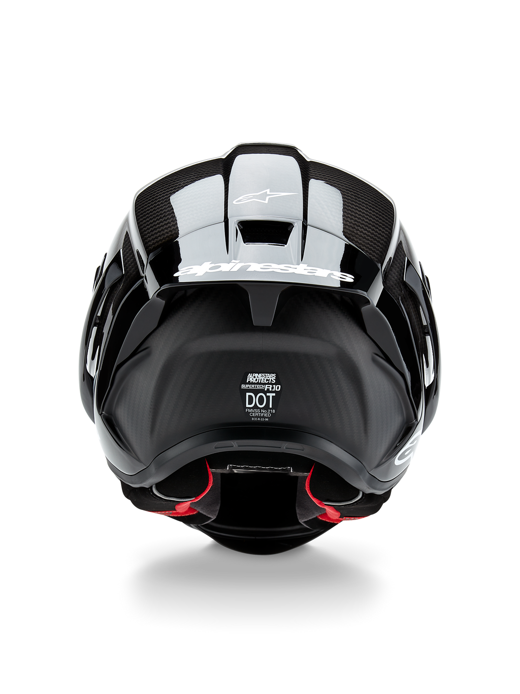 Alpinestars Supertech R10 Solid Helmet, kask motocyklowy, czarny karbon matowy i błyszczący, widok z tyłu prezentujący teksturę włókna węglowego, aerodynamiczny spojler z białym logo Alpinestars, etykiety certyfikacji bezpieczeństwa DOT i ECE oraz czerwona wyściółka wewnętrzna