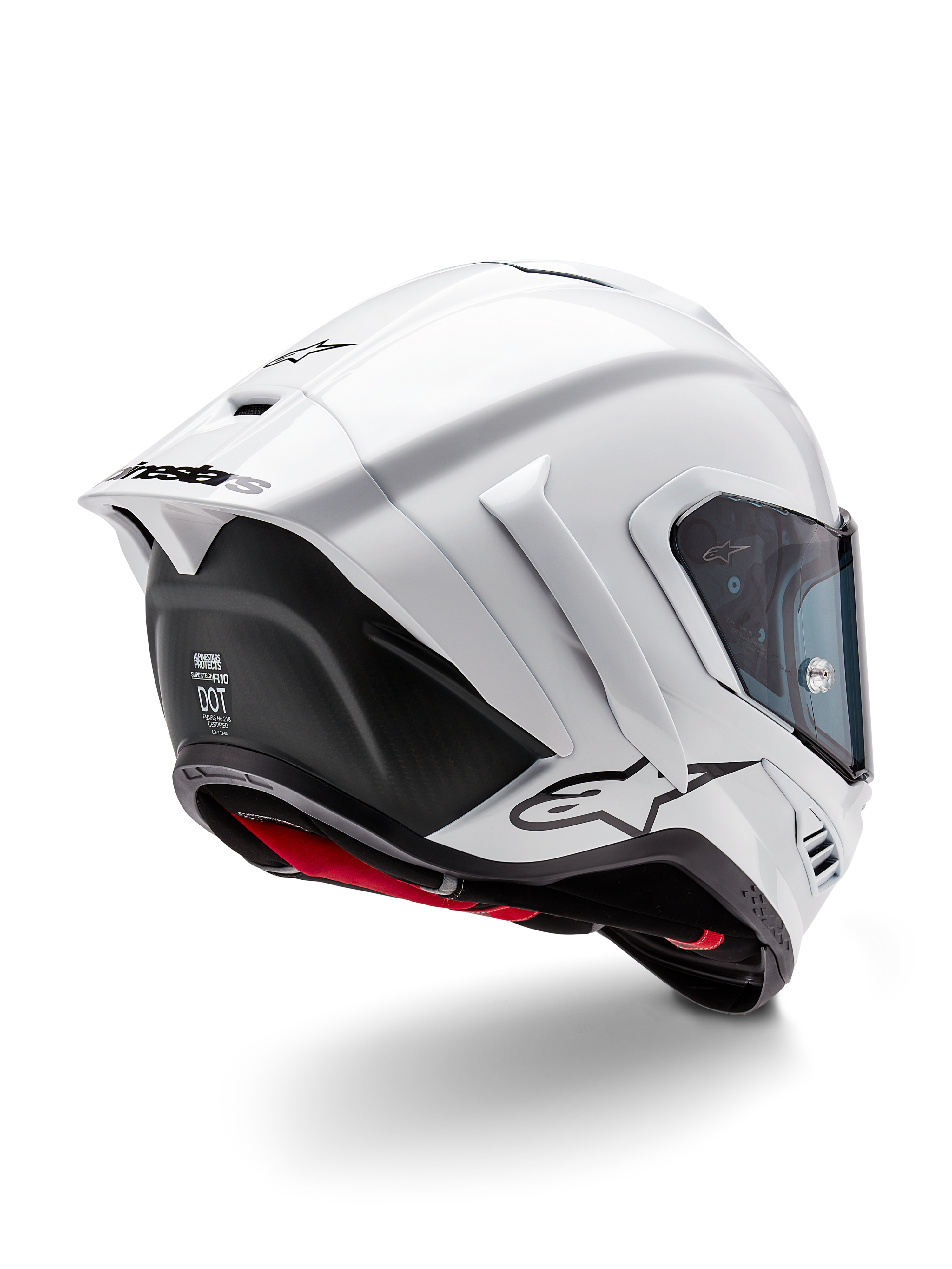 Kask Alpinestars Supertech R10 Solid, pełny kask motocyklowy wyścigowy, biały połysk i czarny mat, widok z tyłu pod kątem trzech czwartych z aerodynamicznym spojlerem, bocznymi skrzydełkami i czarnym logo marki