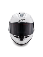 Alpinestars Supertech R10 Solid Helmet, wyścigowy kask typu full-face, biały błyszczący z czarnymi detalami, widok z przodu pokazujący ciemny wizjer, aerodynamiczny system wentylacji i czarne logo Astars