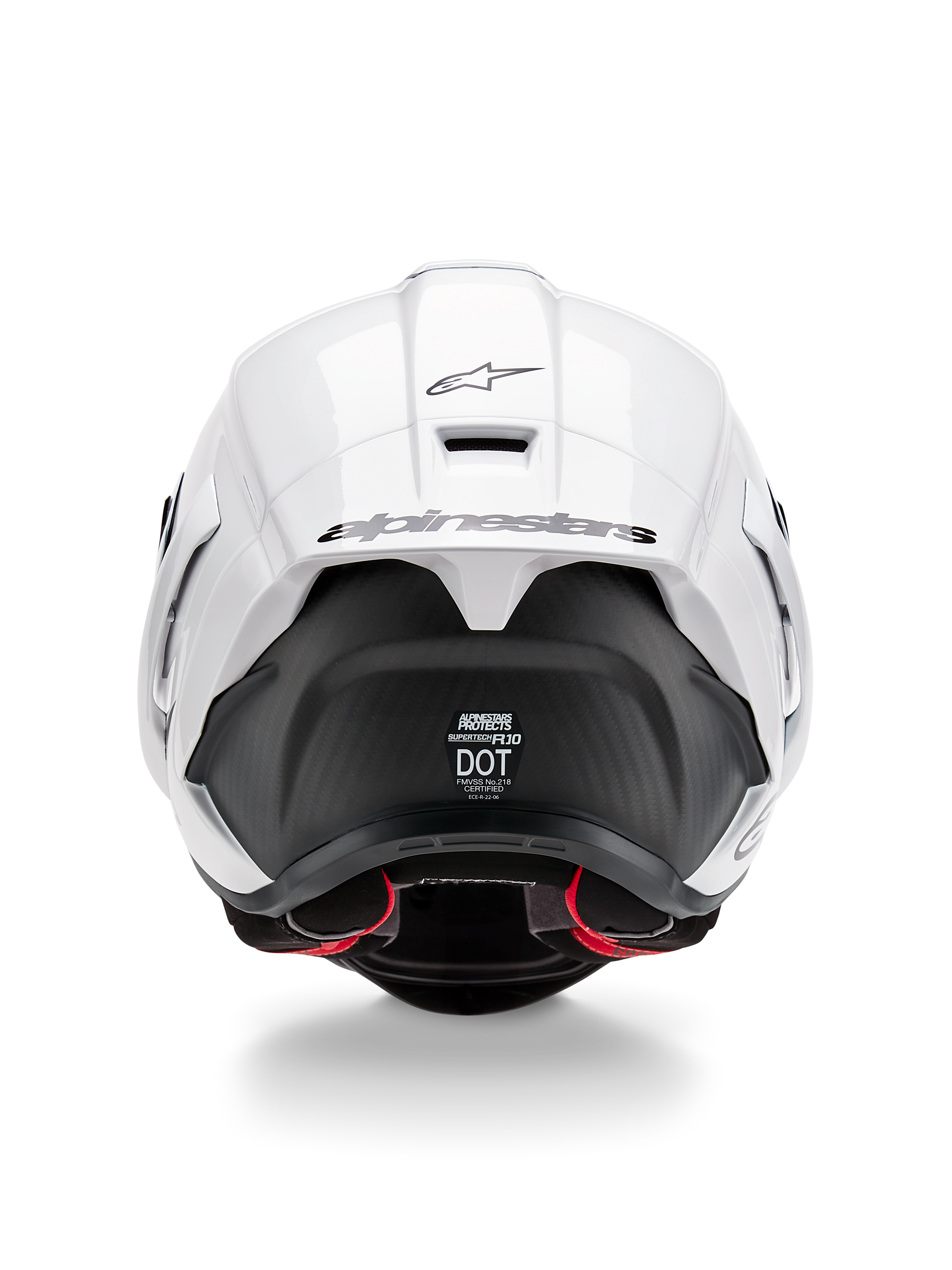 Alpinestars Supertech R10 Solid Helmet, widok z tyłu, biała błyszcząca góra z czarną matową dolną częścią, aerodynamiczny spojler z czarnym logo Alpinestars, widoczna tekstura włókna węglowego i naklejki z certyfikatami bezpieczeństwa